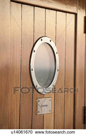 Stock Image - Close-up of a door window at cruise ship Silver Shadow, East China Sea. Fotosearch