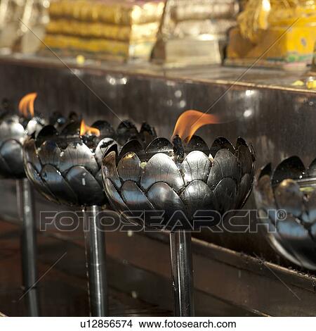 Close-up of oil lamps burning at Wat Phrathat Doi Suthep, Chiang Mai, Thailand View Large Photo Image Picture - Close-up of oil lamps burning at Wat Phrathat Doi Suthep, Chiang Mai, Thailand. Fotosearch