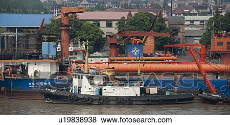 Stock Photo - Container ship at a commercial dock, Yangtze River, Shanghai, China. Fotosearch