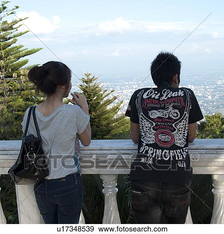 Stock Photo - Couple looking at city view from Wat Phrathat Doi Suthep, Chiang Mai, Thailand. Fotosearch