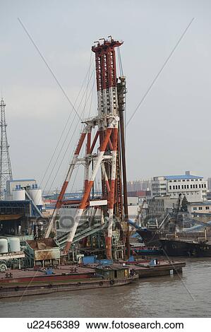 Stock Photo - Cranes at a commercial dock, Yangtze River, Shanghai, China. Fotosearch