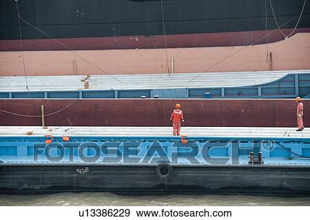 Dock workers on a container ship, Yangtze River, Shanghai, China View Large Photo Image Stock Photo - Dock workers on a container ship, Yangtze River, Shanghai, China. Fotosearch