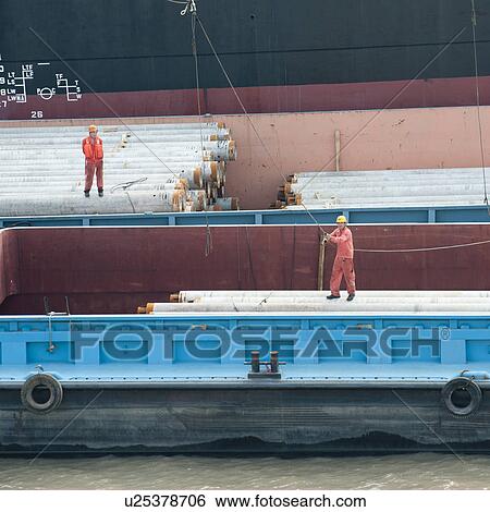 Stock Photograph - Dock workers on a container ship, Yangtze River, Shanghai, China. Fotosearch