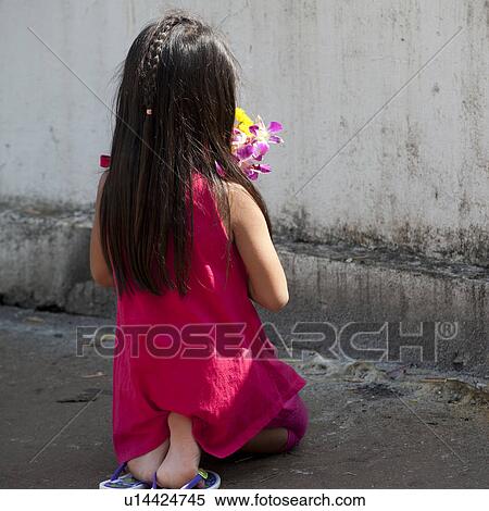 Girl praying in front of a wall of Wat Phra That Doi Kong Mu Temple, Mae Hong Son, Thailand View Large Photo Image Stock Photography - Girl praying in front of a wall of Wat Phra That Doi Kong Mu Temple, Mae Hong Son, Thailand. Fotosearch