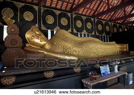 Stock Photograph - Golden statue of reclining Buddha at Wat Chedi Luang, Chiang Mai, Thailand. Fotosearch