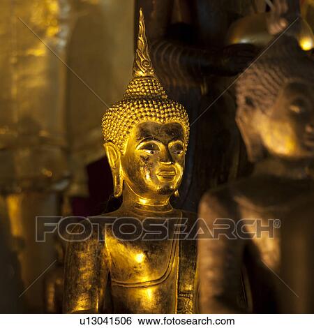 Stock Photograph - Golden statues of Buddha at Wat Phra Singh, Chiang Mai, Thailand. Fotosearch