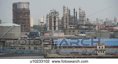 Stock Image - Industry in a city, Yangtze River, Shanghai, China. Fotosearch