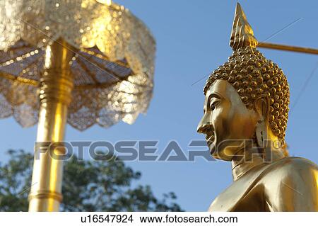 Picture - Low angle view of a Buddha statue at Wat Phrathat Doi Suthep, Chiang Mai, Thailand. Fotosearch
