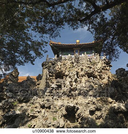 Stock Photo - Low angle view of a pavilion on a cliff at the Imperial Garden, Forbidden City, Beijing, China. Fotosearch