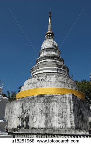 Stock Photo - Low angle view of a stupa at Wat Phra Singh, Chiang Mai, Thailand. Fotosearch