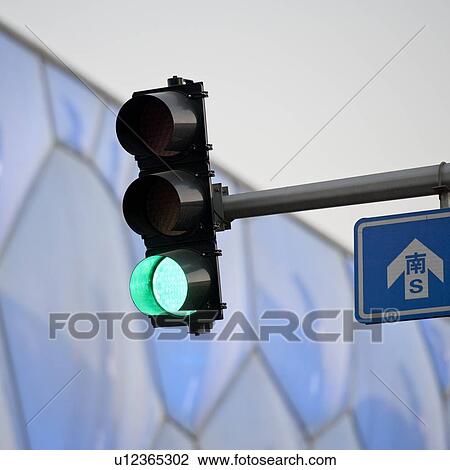Stock Image - Low angle view of traffic light near Beijing National Aquatics Center, Olympic Green, Beijing, China. Fotosearch