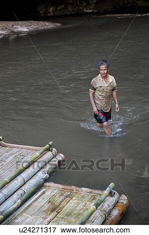 Stock Photo - Man coming out from a river, Thailand. Fotosearch