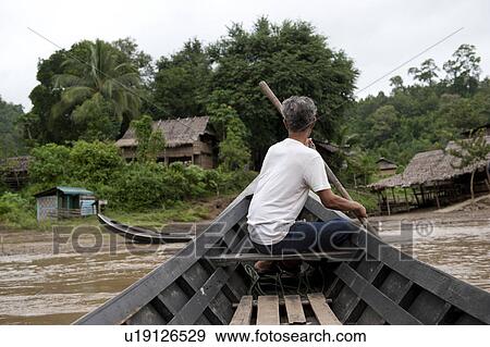 Stock Photo - Man rowing a boat, Huay Pu Keng, Mae Hong Son Province, Thailand. Fotosearch