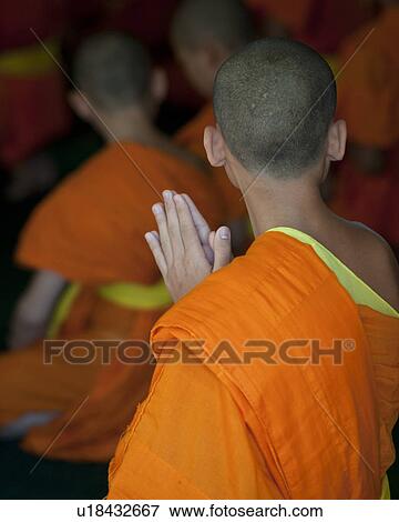 Stock Photo - Novice monks praying at Wat Sri Soda, Chiang Mai, Thailand. Fotosearch