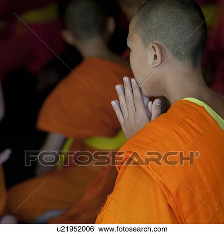 Stock Photograph - Novice monks praying at Wat Sri Soda, Chiang Mai, Thailand. Fotosearch