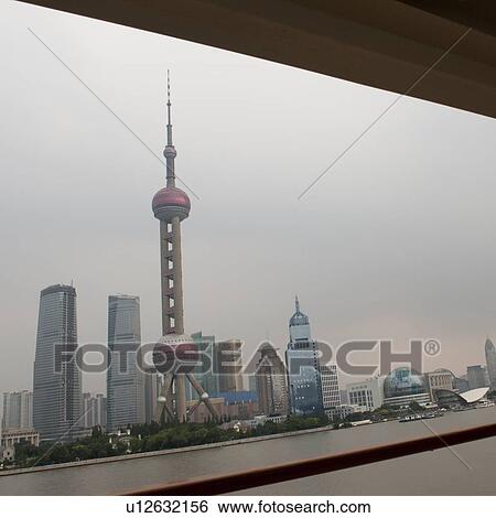 Stock Photograph - Oriental Pearl Tower and city skyline, Huangpu River, Pudong, Shanghai, China. Fotosearch