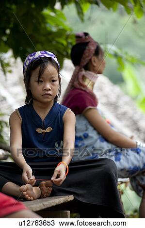 Padaung girl and a woman sitting on a bench, Huay Pu Keng, Mae Hong Son Province, Thailand View Large Photo Image Stock Image - Padaung girl and a woman sitting on a bench, Huay Pu Keng, Mae Hong Son Province, Thailand. Fotosearch
