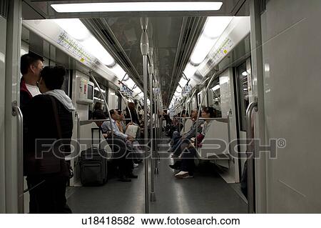 Stock Image - Passengers in a subway train, Shanghai, China. Fotosearch