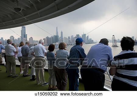 Stock Image - Passengers looking at view, Yangtze River, Shanghai, China. Fotosearch