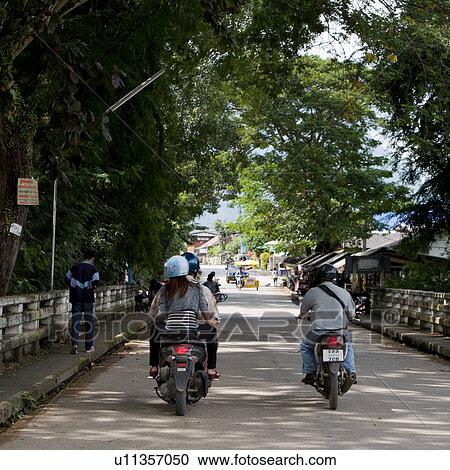 Stock Image - People riding motor cycles on the road, Chiang Dao, Chiang Mai Province, Thailand. Fotosearch