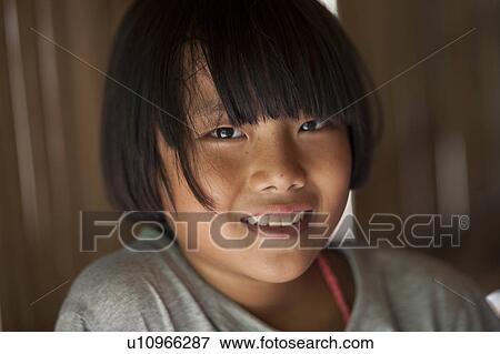 Stock Photo - Portrait of a girl smiling, Chiang Dao, Chiang Mai Province, Thailand. Fotosearch