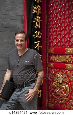 Stock Image - Portrait of a man smiling, Shanghai French Concession, Shanghai, China. Fotosearch