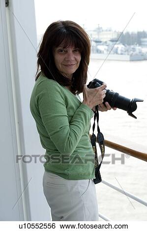 Portrait of a woman photographing with a camera, Yangtze River, Baoshan District, Shanghai, China View Large Photo Image Stock Photograph - Portrait of a woman photographing with a camera, Yangtze River, Baoshan District, Shanghai, China. Fotosearch