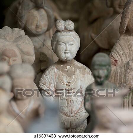 Stock Image - Statues at a market stall, Shanghai, China. Fotosearch
