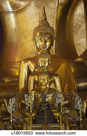 Stock Image - Statues of Buddha at Wat Phra Singh, Chiang Mai, Thailand. Fotosearch