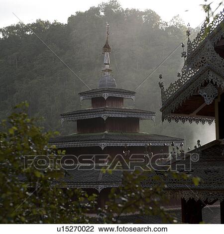 Stock Image - Temple in a forest, Thailand. Fotosearch