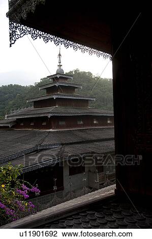 Stock Image - Temple viewed from a window, Thailand. Fotosearch