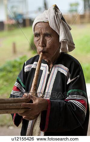 Stock Photograph - Thai woman smoking a hookah pipe, Thailand. Fotosearch