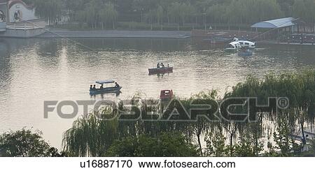 Tourists boating in a river, Binhai, Tianjin, China View Large Photo Image Stock Image - Tourists boating in a river, Binhai, Tianjin, China. Fotosearch