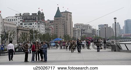 Stock Photo - Tourists with buildings in a city, The Bund, Shanghai, China. Fotosearch