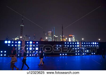 Tourists with Oriental Pearl Tower and city skyline in the background, The Bund, Pudong, Shanghai, China View Large Photo Image Stock Photography - Tourists with Oriental Pearl Tower and city skyline in the background, The Bund, Pudong, Shanghai, China. Fotosearch