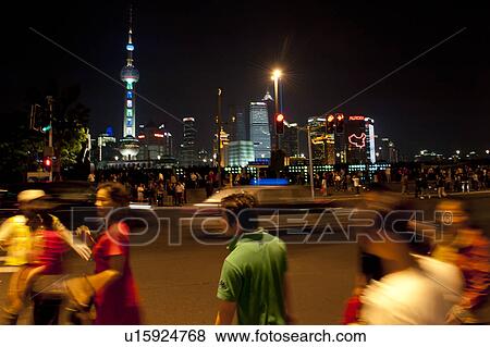 Stock Photo - Tourists with the Oriental Pearl Tower in the background, The Bund, Pudong, Shanghai, China. Fotosearch