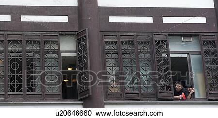 Two people leaning against a window, Shanghai, China View Large Photo Image Stock Image - Two people leaning against a window, Shanghai, China. Fotosearch