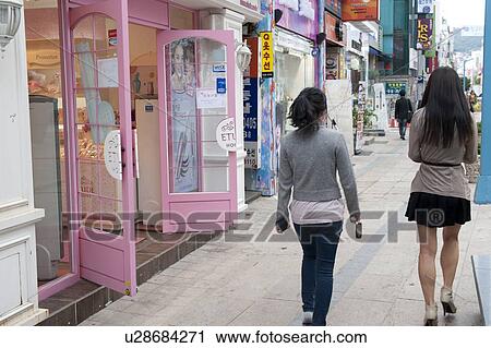 Stock Image - Two women walking in a market, Busan, Yeongnam, South Korea. Fotosearch
