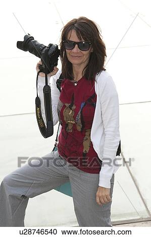 Stock Image - Woman holding a digital camera, Binhai, Tianjin, China. Fotosearch