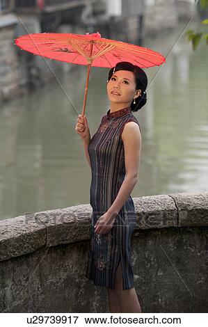 Stock Photo - Woman holding a parasol, Suzhou, Jiangsu Province, China. Fotosearch