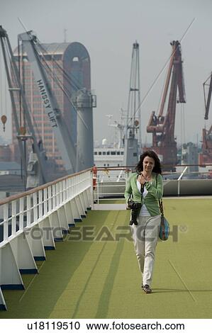 Stock Image - Woman in a cruise ship, Yangtze River, Shanghai, China. Fotosearch