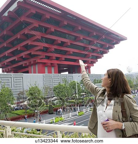 Picture - Woman pointing at China pavilion in Shanghai World Expo, Shanghai, China. Fotosearch