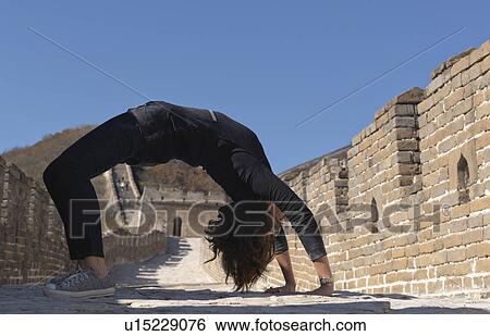 Woman practicing yoga at the Mutianyu section of the Great Wall of China, Beijing, China View Large Photo Image Stock Photograph - Woman practicing yoga at the Mutianyu section of the Great Wall of China, Beijing, China. Fotosearch