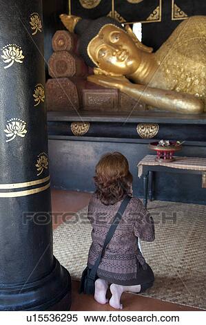 Stock Photography - Woman praying at Wat Chedi Luang, Chiang Mai, Thailand. Fotosearch