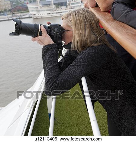 Woman taking a picture of a city, Shanghai, China View Large Photo Image Stock Photograph - Woman taking a picture of a city, Shanghai, China. Fotosearch