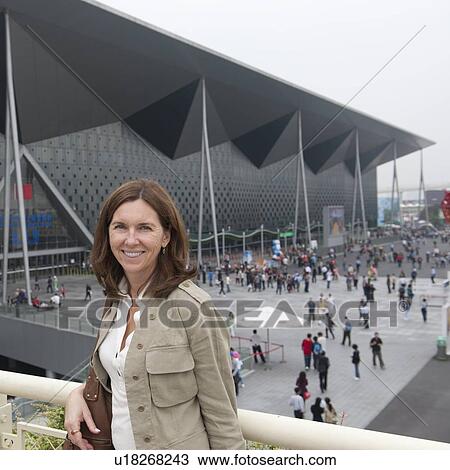 Stock Image - Woman with Theme Pavilion in the background, Shanghai, China. Fotosearch