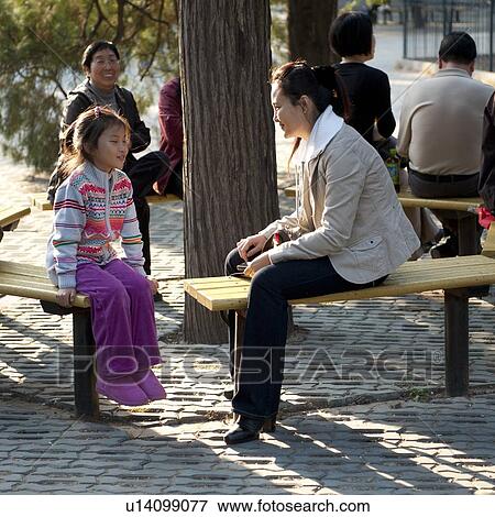 Women sitting on the bench with her daughter at the Temple Of Heaven, Beijing, China View Large Photo Image Stock Photo - Women sitting on the bench with her daughter at the Temple Of Heaven, Beijing, China. Fotosearch