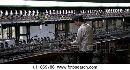 Stock Photograph - Worker in a silk factory, Suzhou, Jiangsu Province, China. Fotosearch