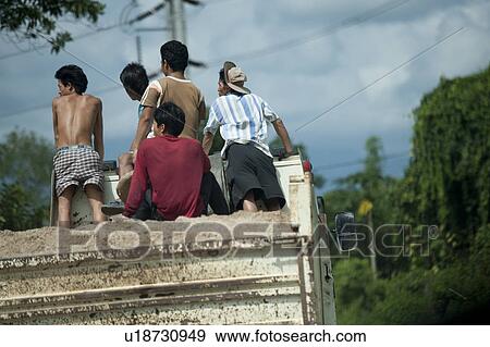 Stock Photo - Workers in a truck loaded with sand, Thailand. Fotosearch