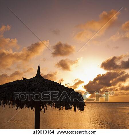 Aruba, silhouette of palapa on beach at sunset View Large Photo Image Picture - Aruba, silhouette of palapa on beach at sunset. Fotosearch